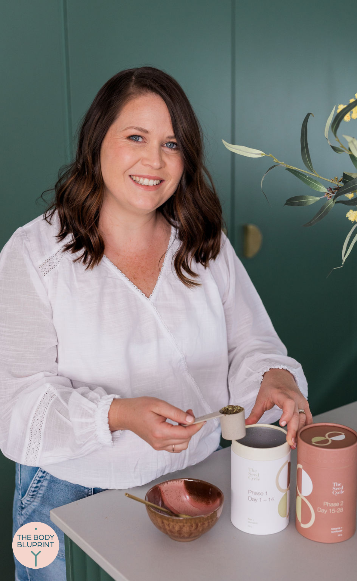 Hannah, a TTC fertility coach pictured with The Seed Cycle seeds used for hormonal balance.